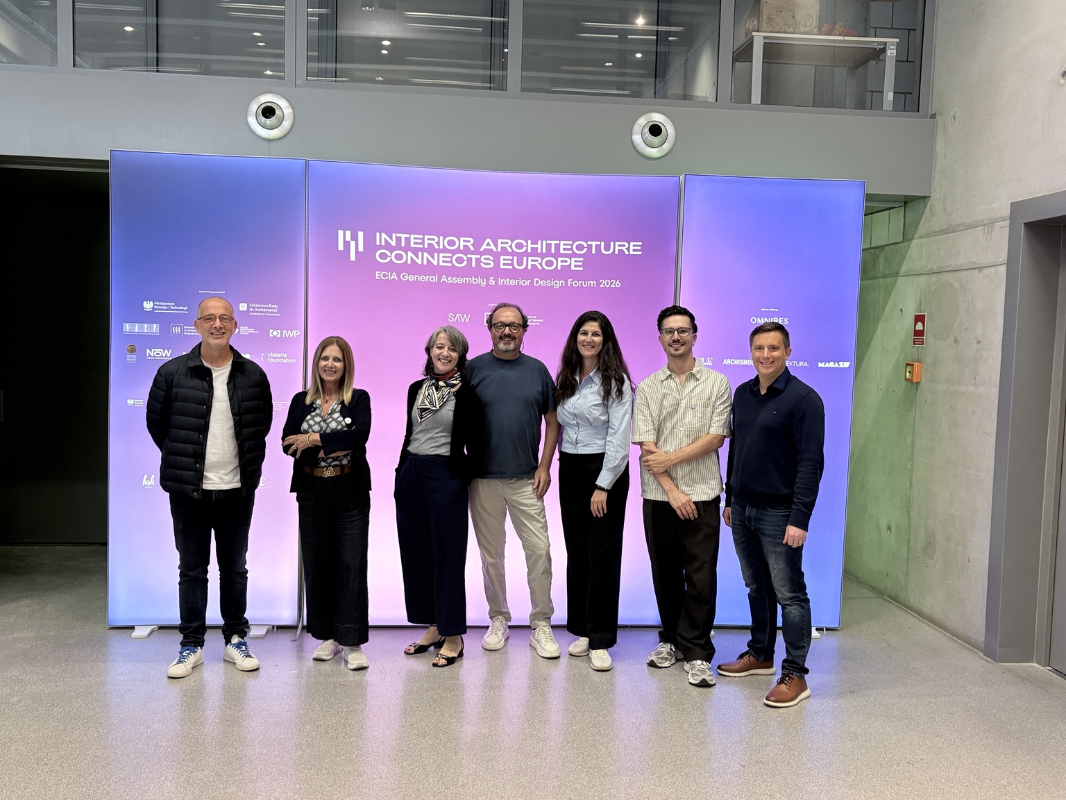 Group photograph of MIA representatives from Italy, Spain, France and Malta in front of the ECIA General Assembly & Interior Design Forum 2026 backdrop in Warsaw.
