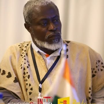 A Build in Africa delegate listening across the meeting table.