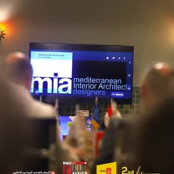 MIA presentation viewed across the international meeting table.