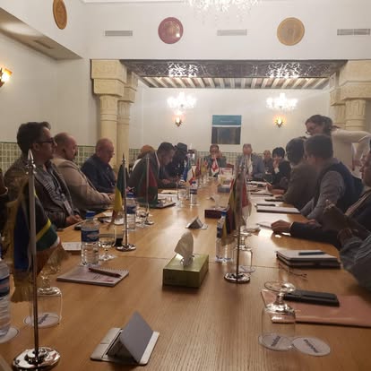 International representatives seated around a working table in Hammamet.
